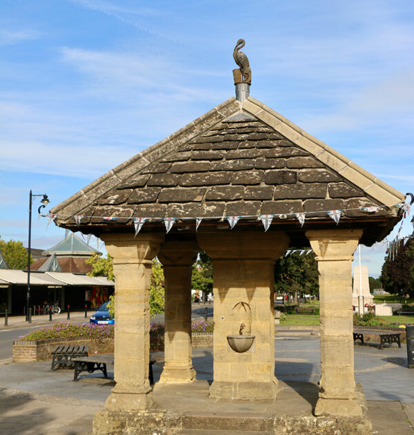 The Fountain in Cranleigh today with the stone crane clearly visible at the apex of the tiled roof